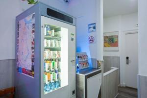 a room with a refrigerator with drinks in it at Hotel Titus City Centre in Amsterdam