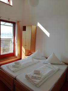 a bedroom with a bed with two towels on it at Naturfreundehaus Bodensee in Radolfzell am Bodensee