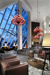 a lobby with couches and chairs and large windows at Antony Palace Hotel - Venice Airport in Marcon