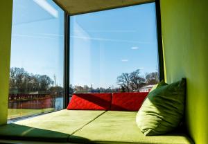 a bed in a room with a large window at Jugendherberge Schweinfurt in Schweinfurt