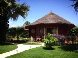 a small hut with a grass roof at Keur Palmier Saly in Saly Portudal