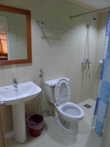 a bathroom with a toilet and a sink at Cebuview Tourist Inn in Cebu City