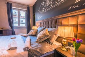 a bedroom with a large bed with a headboard at Seven Stories Rooms, 4th Floor, no elevator in Zagreb