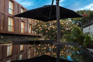a black umbrella sitting in front of a building at ARTS IN Hotel Conde Carvalhal in Funchal