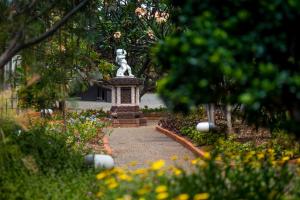a statue of a dog in a garden at ARTS IN Hotel Conde Carvalhal in Funchal