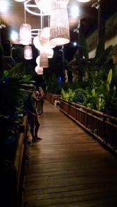 a group of people walking down a boardwalk in a store at Suites at Mayan Palace Vidanta Resort Riviera Maya in Playa del Carmen