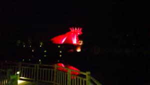 a red horse statue is lit up at night at Suites at Mayan Palace Vidanta Resort Riviera Maya in Playa del Carmen