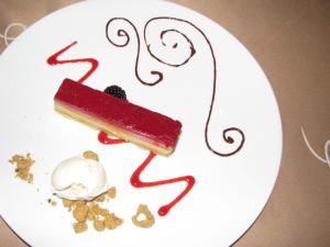 a white plate with a piece of cake and ice cream at Suites at Mayan Palace Vidanta Resort Riviera Maya in Playa del Carmen