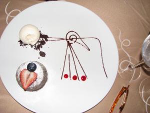 a white plate with some food on a table at Suites at Mayan Palace Vidanta Resort Riviera Maya in Playa del Carmen
