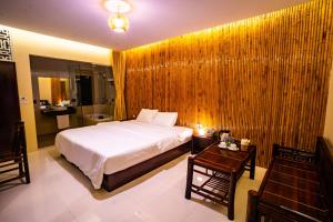 a bedroom with a bed and a table and a bathroom at Trang An Retreat in Ninh Binh
