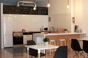 a kitchen with a table and chairs and a counter at Trevejo Hostel in Garachico