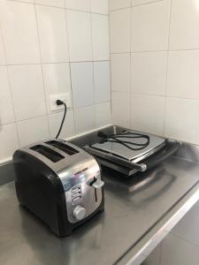 a toaster sitting on top of a kitchen counter at Black Sheep Medellin in Medellín