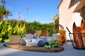 a table with a cutting board with food on it at Chambres d'hôtes Villa Cardabella in Le Tignet