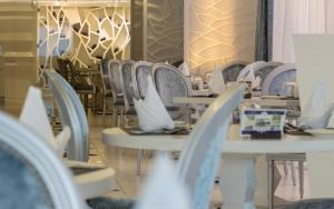 a row of tables and chairs in a restaurant at Adams Beach Hotel & Spa in Ayia Napa