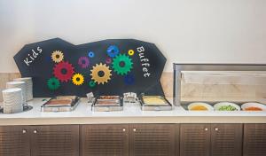 a table with a sign with some food on it at Adams Beach Hotel & Spa in Ayia Napa