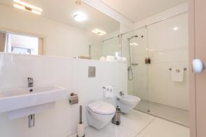 a bathroom with a toilet and a sink and a shower at ARTS IN Hotel Conde Carvalhal in Funchal