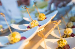 a row of plates of food on a table at Adams Beach Hotel & Spa in Ayia Napa