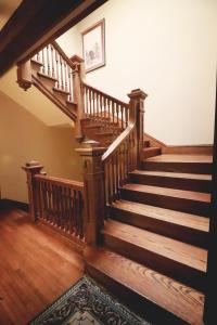 a staircase leading up to a room with a wooden floor at Inn at 835 Boutique Hotel in Springfield