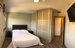 Postel nebo postele na pokoji v ubytování Apartamentos Augusto