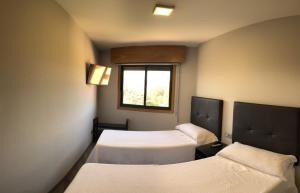 Postel nebo postele na pokoji v ubytování Apartamentos Augusto