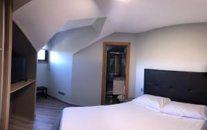 Postel nebo postele na pokoji v ubytování Apartamentos Augusto