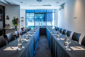 a conference room with a long table with wine glasses at Hotel Chico 97 in Bogotá