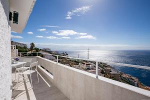 a balcony with a table and a view of the ocean at Breathtaking 180 degrees Views in Tabaiba Alta in Santa Cruz de Tenerife