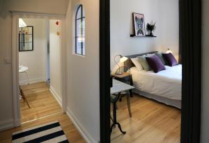 a bedroom with a bed and a table and a mirror at Troisième Droite in Cahors
