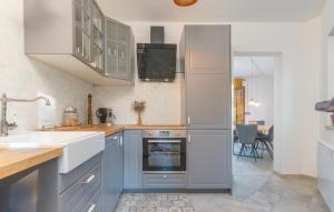 a kitchen with blue cabinets and a sink and an oven at Villa Bogijeva in Rabac