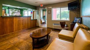 a waiting room with a couch and a table at SureStay Plus Hotel by Best Western Bettendorf in Bettendorf