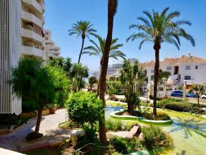 a view of a resort with palm trees at G&G Benalbeach Sea Views in Benalmádena