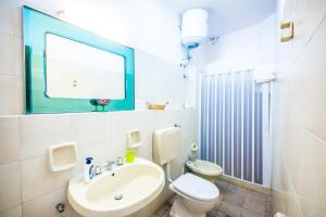 a bathroom with a sink and a toilet and a mirror at Casa MARINELLA in Lipari +44 photos