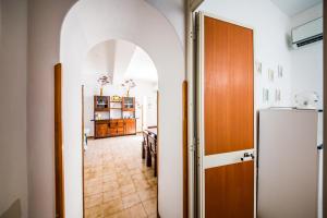 an archway leading into a kitchen with a refrigerator at Casa MARINELLA in Lipari