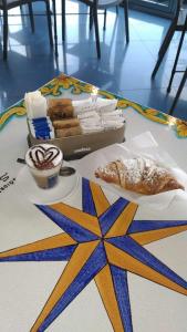 a table with a tray of pastries and aasteryasteryasteryasteryasteryastery at Case Vacanza Calamaro in Trabia