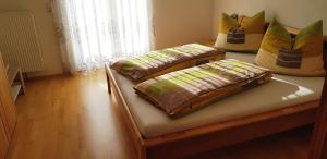 two beds with pillows on top of them in a room at Ferienhaus Anke - Ausseerland Salzkammergut in Pichl bei Aussee