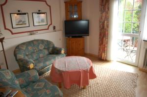 a living room with a couch and a table at Wieting´s Hotel in Esens