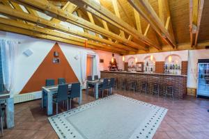 a restaurant with tables and chairs and a bar at Penzion Forest in Rozvadov