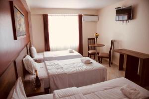 Postel nebo postele na pokoji v ubytování Hotel Central