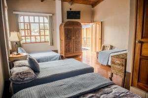 Cama o camas de una habitación en Hotel Casa de las Fuentes