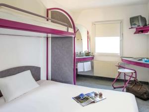 a bedroom with a bunk bed with a magazine on it at T3 Budget Zwickau in Zwickau