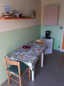 a table in a kitchen with a table cloth on it at Vanni's House in Cannobio