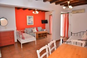 a living room with a couch and a table at Paradisia Villas in Naxos Chora