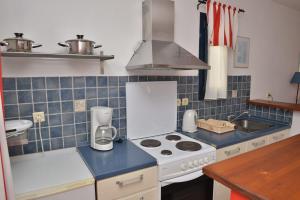 a kitchen with a stove top oven next to a sink at Paradisia Villas in Naxos Chora