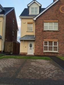 a brick house with a brick driveway at Portstewart - holiday let in Portstewart