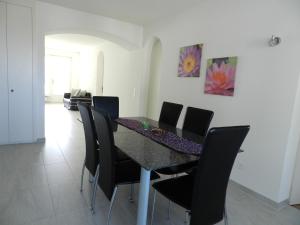 a dining room with a black table and black chairs at Vaduz Zentrum Meierhof in Vaduz