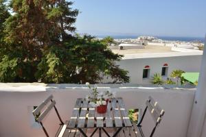 a table and two chairs on a balcony at Paradisia Villas in Naxos Chora