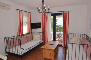 a living room with a couch and a table at Paradisia Villas in Naxos Chora