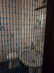 a shower curtain with blue beads on it at Apart 140m2 Promenade Ouest 12persons in Nice