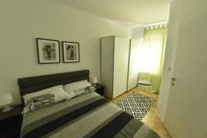 a bedroom with a large bed in a room at Apartments ZAGREB TALES in Zagreb