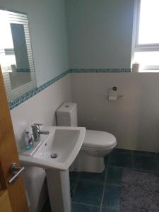 a bathroom with a white toilet and a sink at Portstewart - holiday let in Portstewart